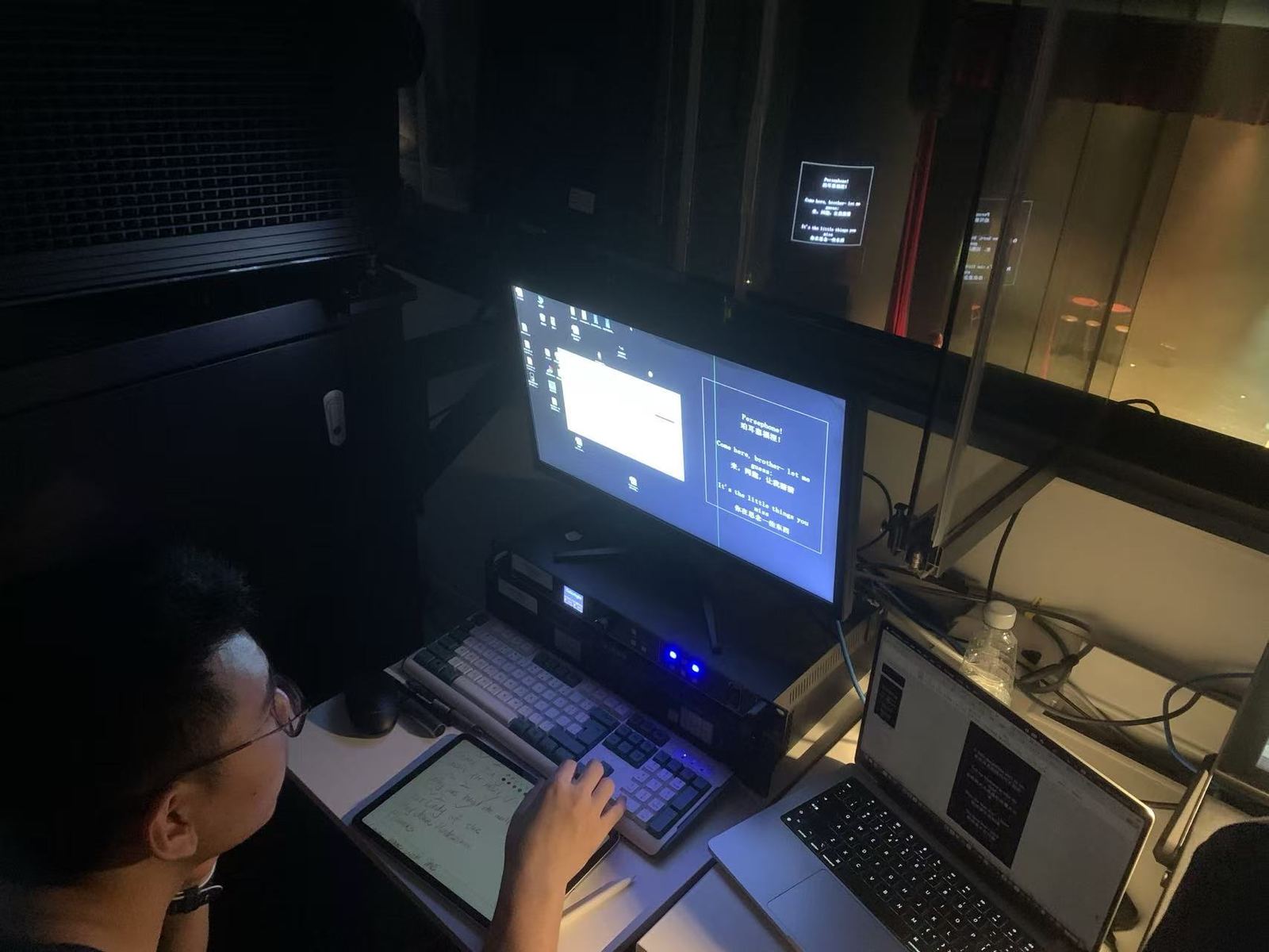 Tianqiqi at a backstage desk calling bilingual subtitles for a stage play