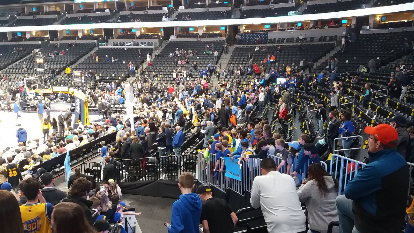Fans waiting along the court before a basketball game
