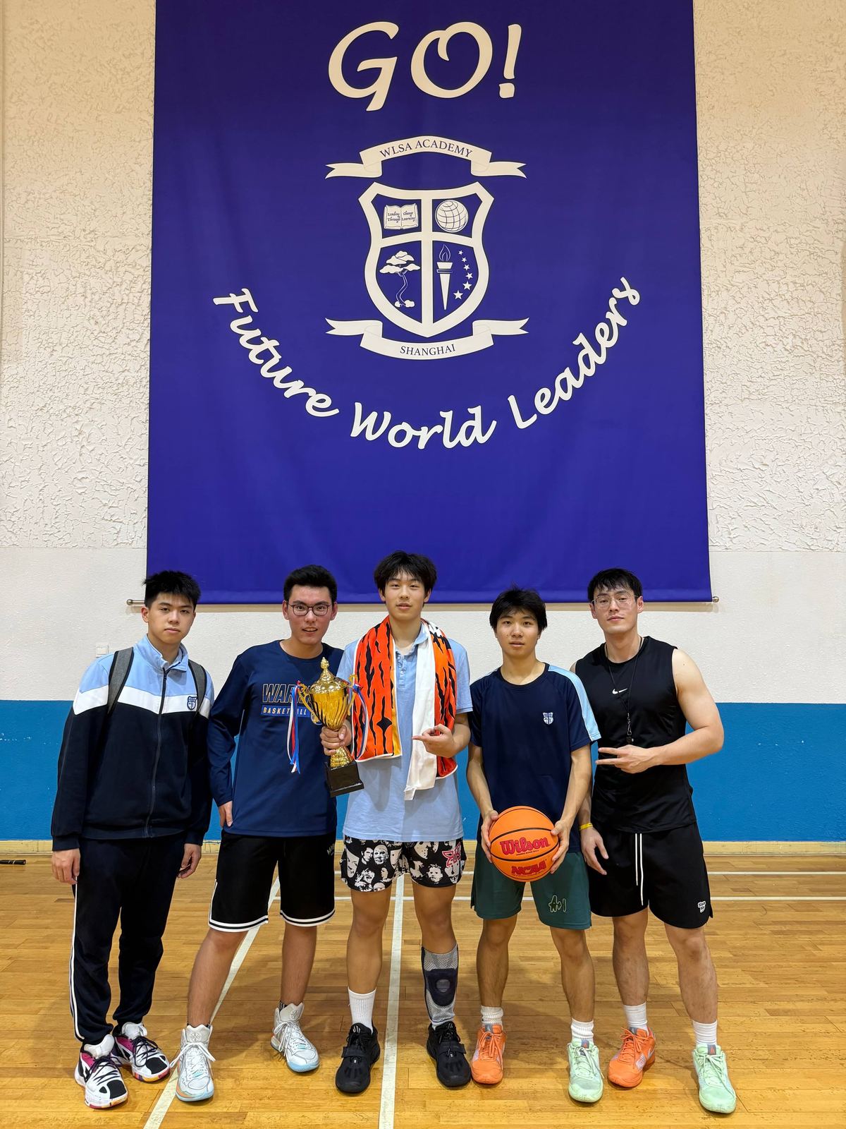 The WLSA 3-on-3 team in front of the school banner